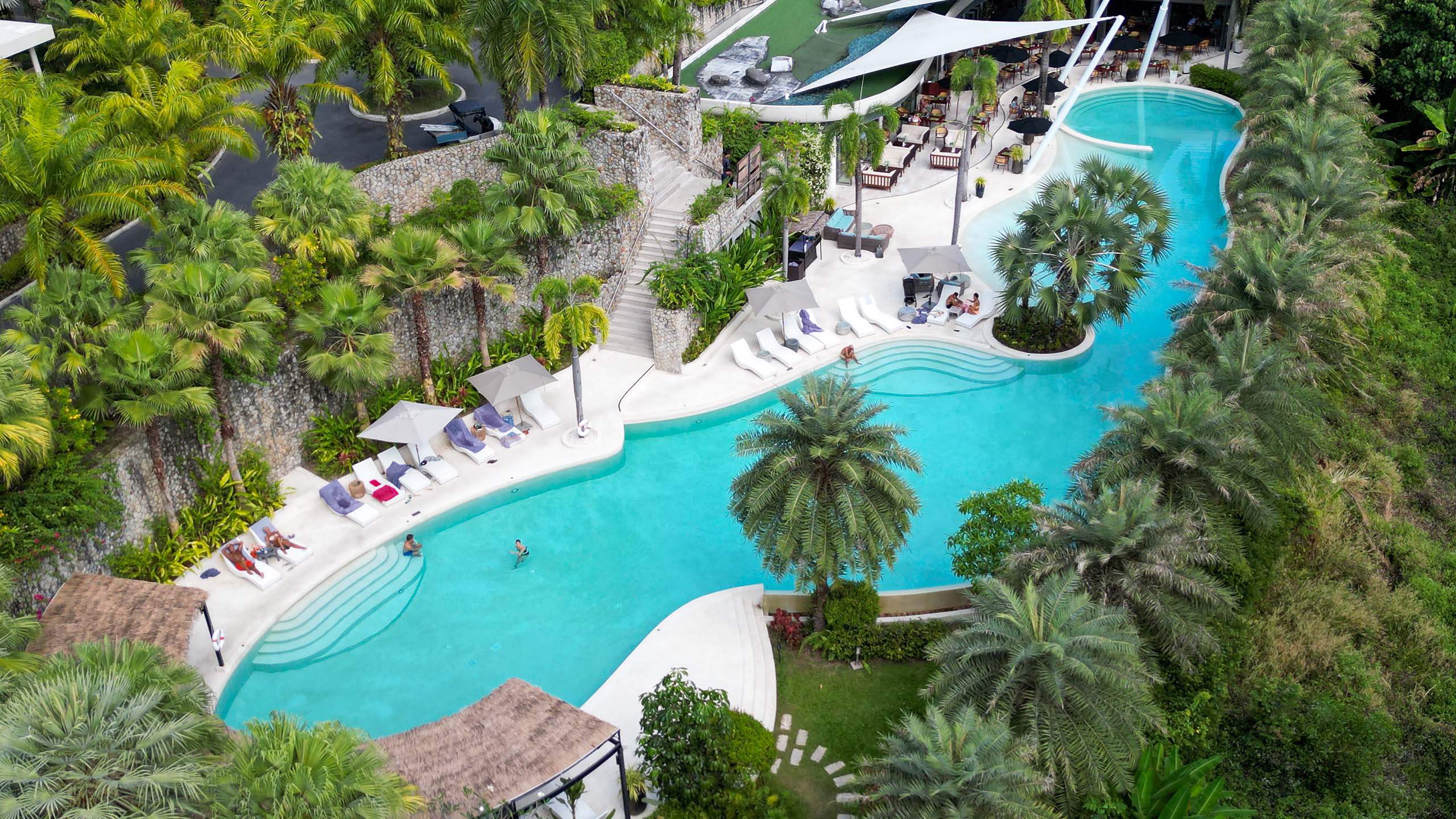 Hotel resort luxury pool with poolside bar and seating area