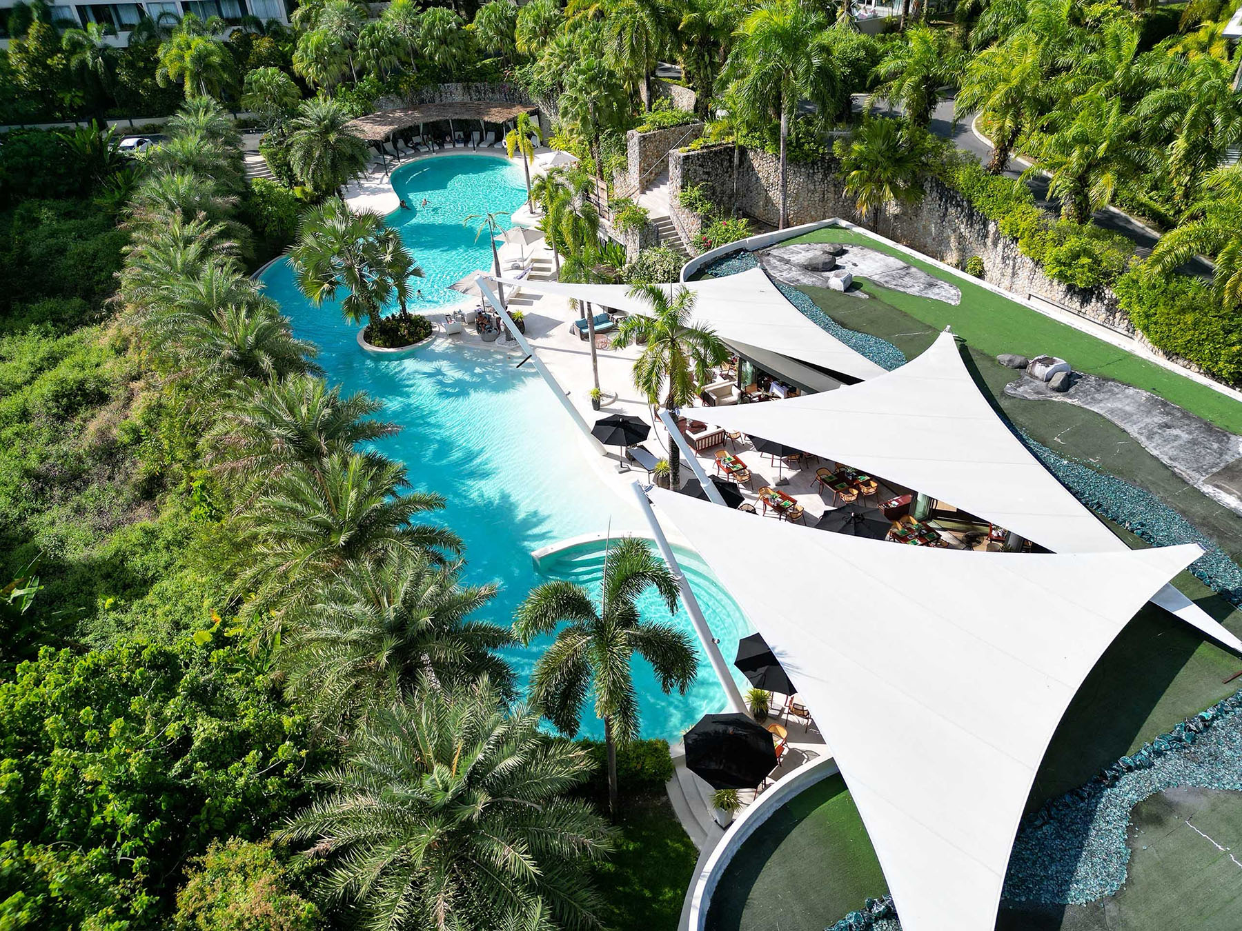 Hotel resort luxury pool with poolside bar and seating area